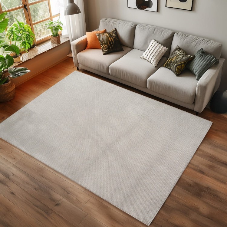 dywan-nowoczesny-helix-jednobarwny-kremowy-arnzacja-na-ciemnej-podlodze-z-jasna-sofa.jpg