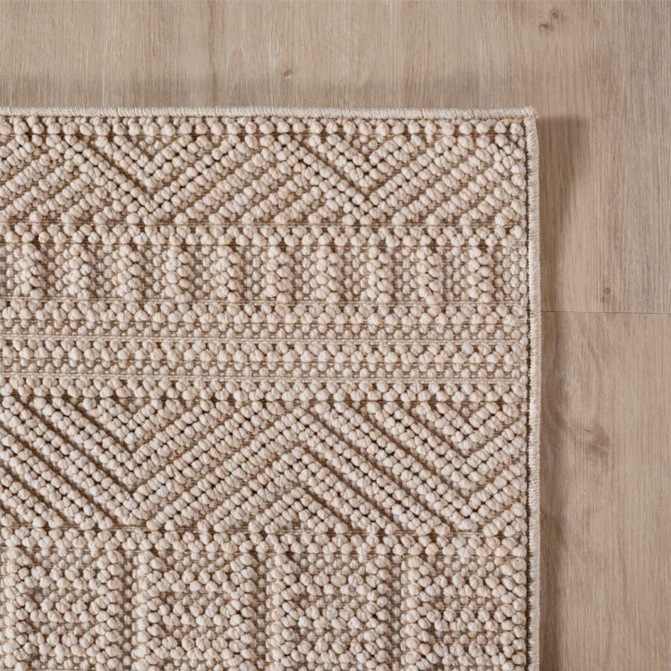 dywan-nowoczesny-3d-helix-boho-bezowy-zblizenie-rogu-dywanu-z-widocznym-obszyciem-obu-bokow.jpg