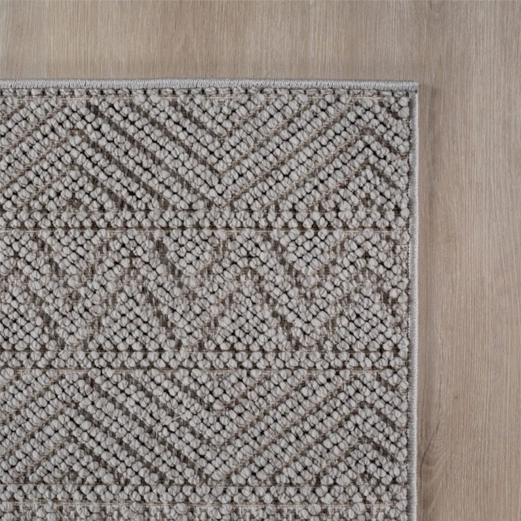 dywan-nowoczesny-3d-helix-boho-szary-zblizenie-rogu-dywanu-z-widocznym-obszyciem-obu-bokow.jpg