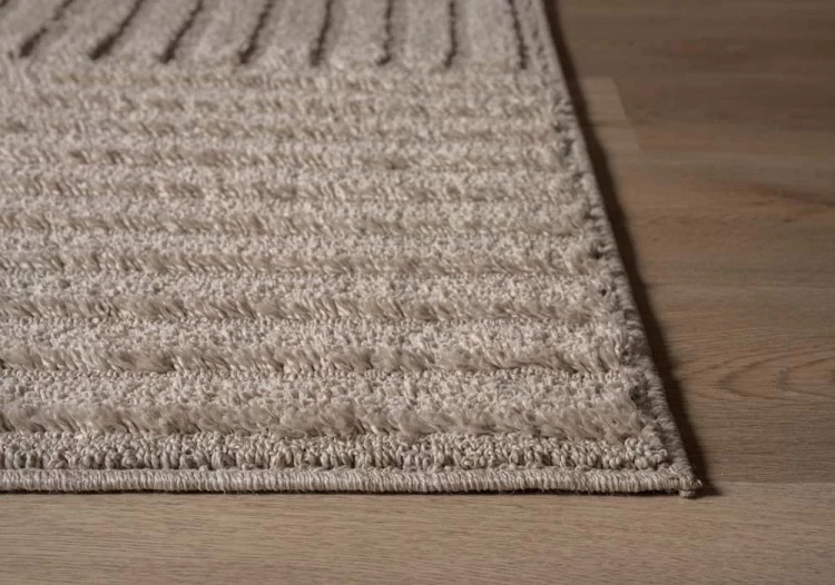 Scandinavisch-vloerkleed-arc-edge-beige-close-up-rand.webp
